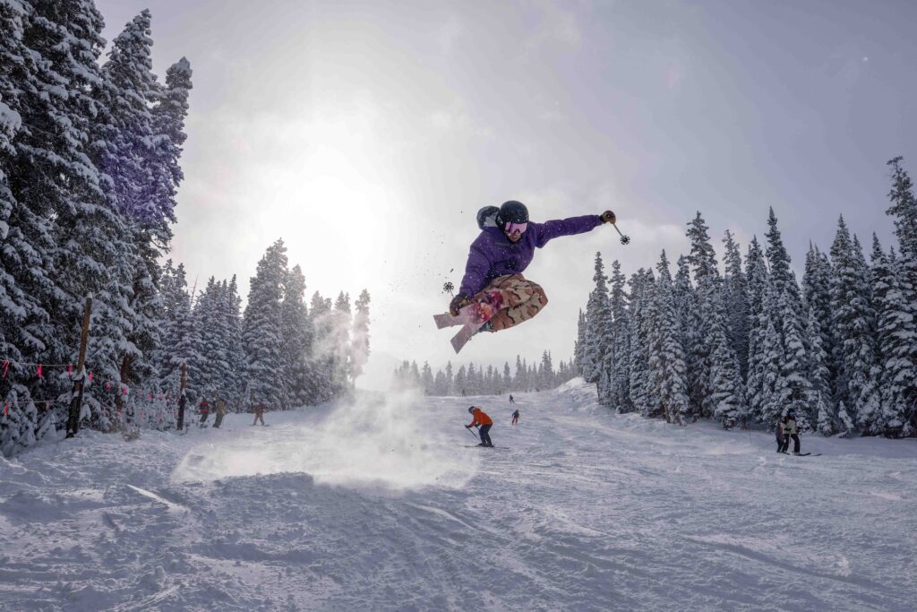 Skier catching air on opening day at Arapahoe Basin