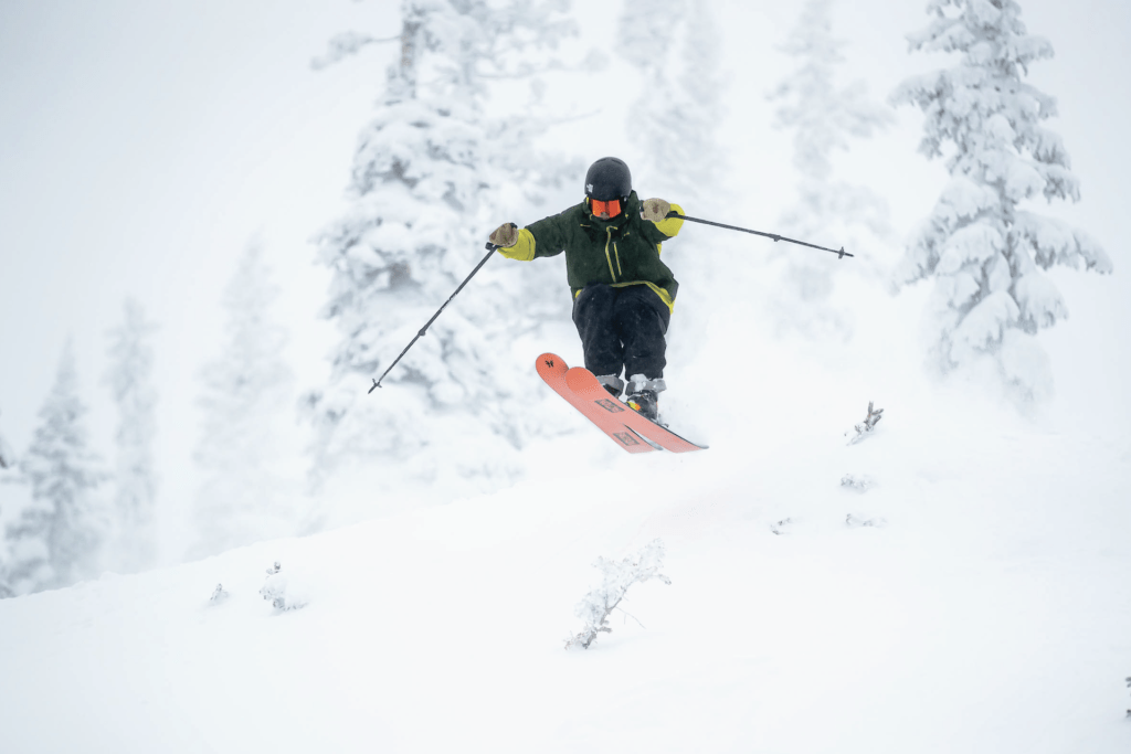 Skier catching air on a powder day at Monarch Mountain