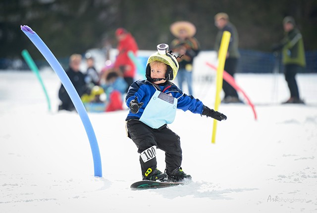 Snow Trails OH annual carnival, boy riding snowboard.