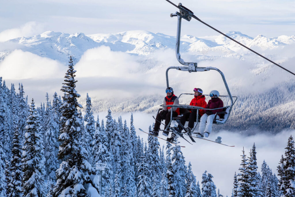 Group of skiers on the chairlift at Whistler on a powder day