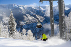 Skiing under gondola at Telluride Ski Resort on a sunny day