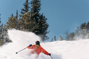Skiing through powder on a bluebird day in Montana