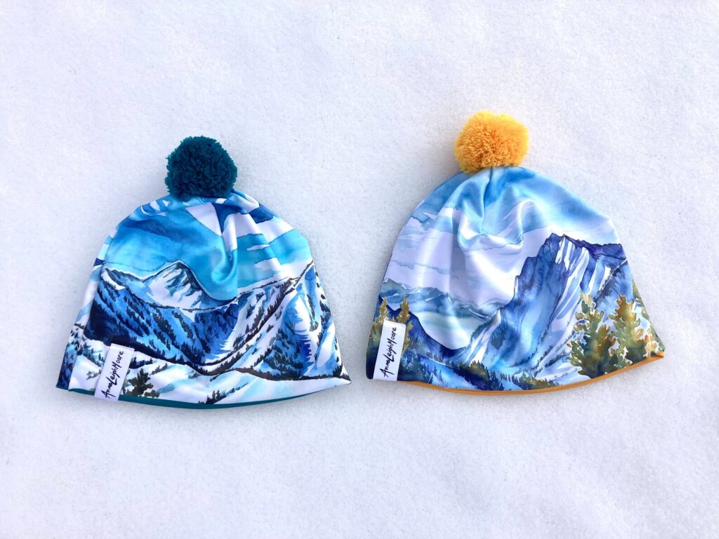 Beanies featuring Utah mountain scenery painted by artist Anna Leigh Moore