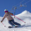 Woman skiing down slopes on a sunny day at Mt. Bachelor Ski Resort