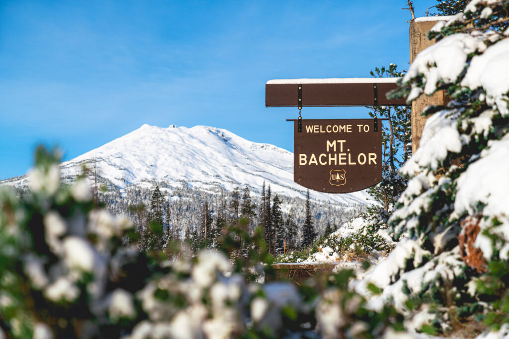 Welcome to Mt. Bachelor sign with mountain behind it