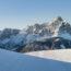 Skiers taking a break on groomed run at 3 Zinnen Dolomites