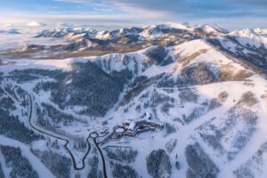 Aerial of Montage Deer Valley covered in snow on a sunny day