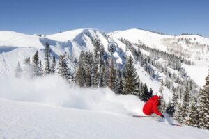 Skiing through powder at Montage Deer Valley on a bluebird day