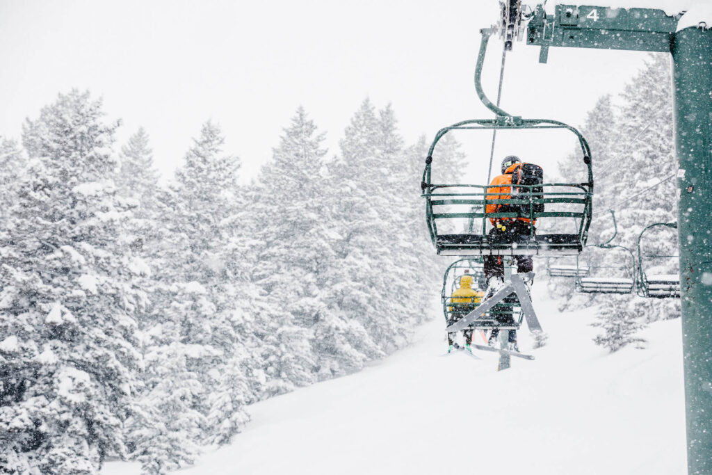 Snowing while people go up chairlift at Sun Valley