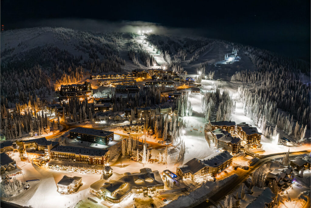 Aerial of Big White Ski Resort lit up at night for night skiing