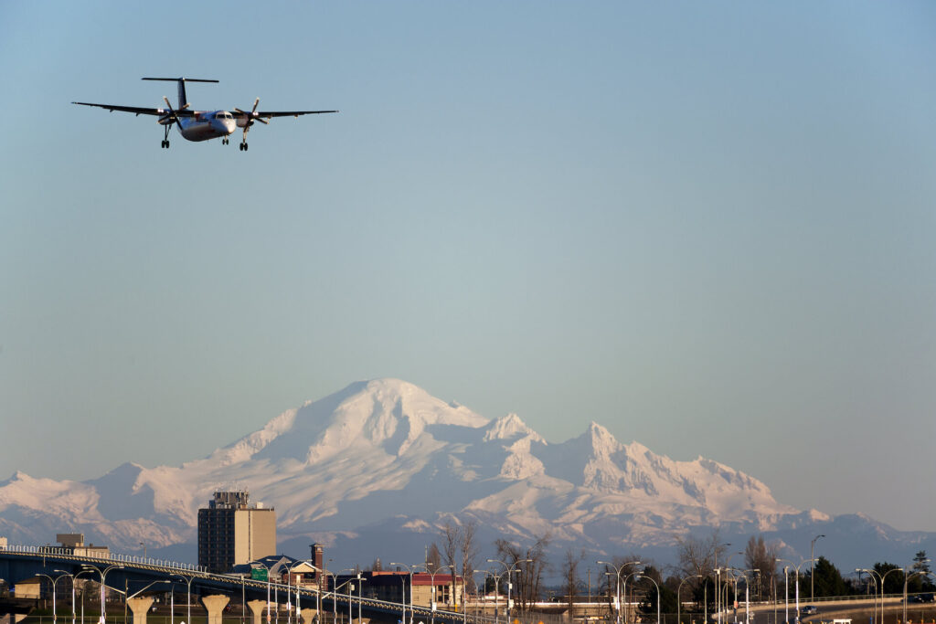 Plane flying into Vancouver International Airport in British Columbia on a sunny day