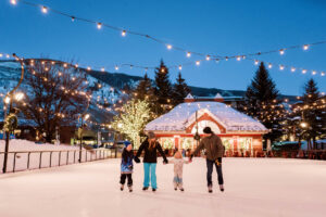 Family ice skating at dusk in Aspen