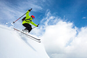 Person skiing through powder on a bluebird day