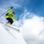 Person skiing through powder on a bluebird day