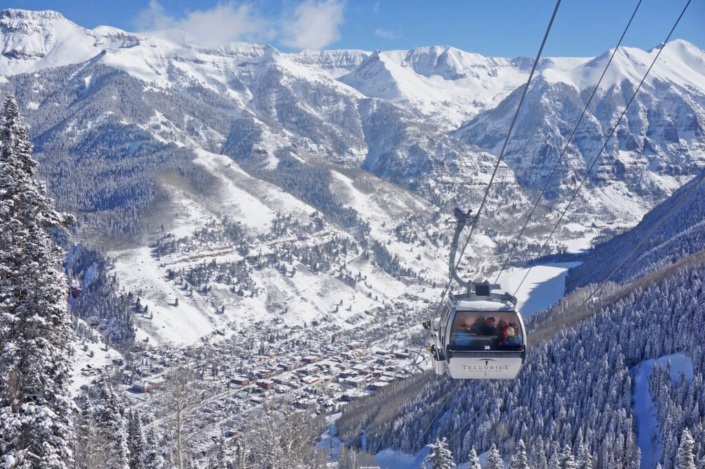 Telluride gondola on a sunny winter day above the slopes