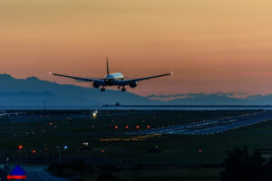 Plane about to at Vancouver's YVR Airport at sunset