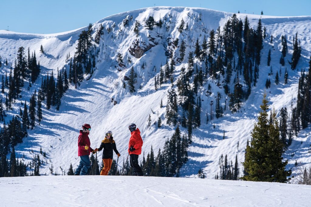 Group of friends taking a break on slopes in Park City on a sunny day