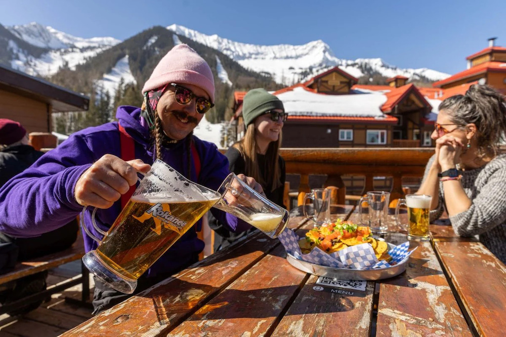 Pouring beer from pitcher on deck of Griz Bar at Fernie Alpine Resort