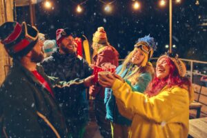 Lively outdoor holiday party with friends in ski gear