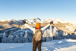 Person raising arms in excitement in the backcountry of Mammoth Lakes