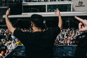 DJ hyping the crowd up on a sunny spring day at Mammoth Mountain Ski Resort