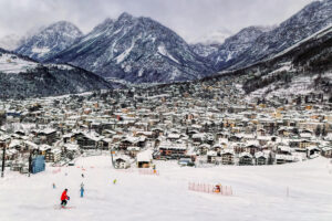 People skiing slopes toward the town of Bormio Italy