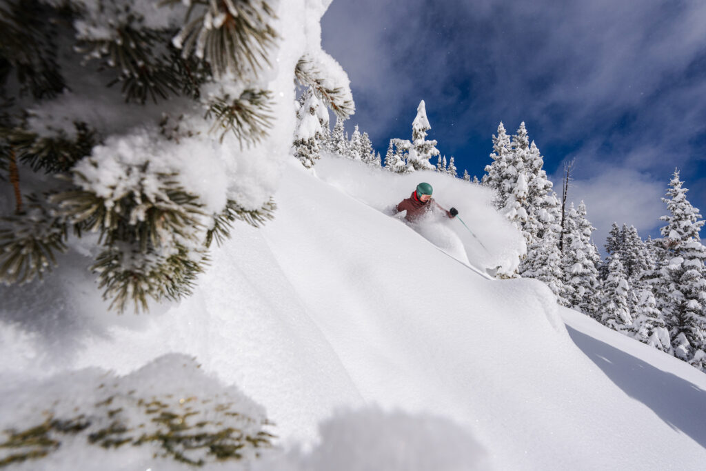 Person skiing through untouched powder at Taos Ski Valley