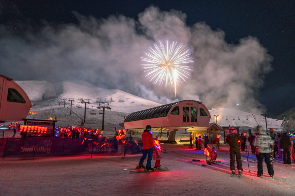 Skiers watching fireworks go off over Sun Valley Ski Resort