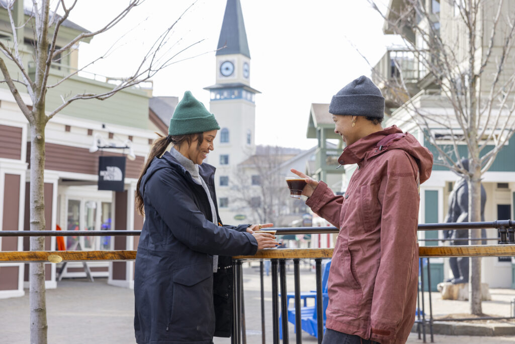 Friends enjoying a drink together on patio in Stratton Village