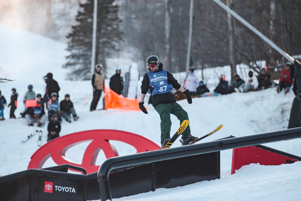 Participant of rail jam grinding on Rails
