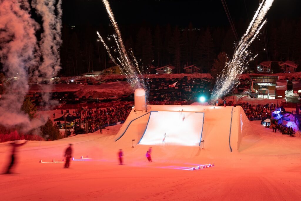 Skiers skiing toward jump for Heavenly Mountain Resort Air & Apres Event